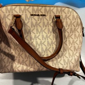 White and Brown MK purse. Can be used as a crossbody or regular tote.